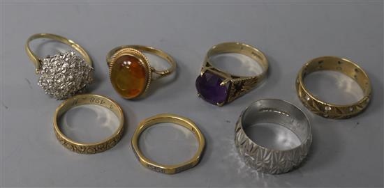 Four various 9ct gold textured rings, one gypsy-set, a 9ct gold and amethyst ring, a similar amber ring and a modernist ring (7).